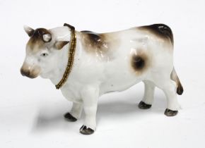 Gilt metal mounted porcelain table snuff in the form a bull, with blue crossed swords mark but
