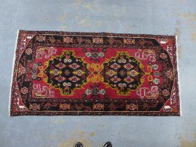 Persian rug, red field with two medallions and Rug with red field and flowerhead border, 202 x