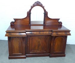 A Victorian mahogany mirror back sideboard, arched back with crested carving, inverted base with