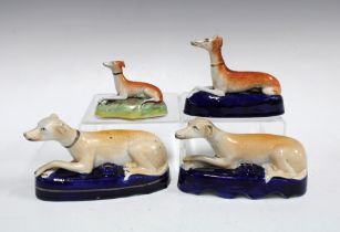 A group of Staffordshire greyhound quill holders, 17cm long (4)