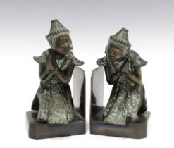 A pair of Thai style bronze patinated figural bookends, 19cm (2) (one is loose on the base)