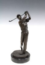Bronze patinated metal figure of a golfer in full swing, on a marble base, 33cm