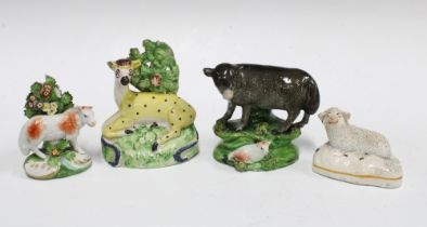 A group of 19th century Staffordshire animals to include a Pearlware cow and calf, and yellow glazed