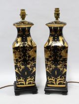 A pair of chinoiserie square form baluster table lamps, with black ground and and gold dragon