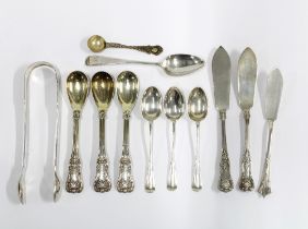 A collection of silver spoons a set of Georgian silver sugar tongs, silver butter knives, etc all