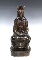 Guanyin, a wooden figure modelled seated, 48cm
