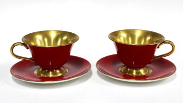 The Royal Collection, a pair of red glazed porcelain cups and saucers (4)