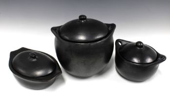 Set of three black glazed pottery vessels with covers, largest 28 x 31cm (3)
