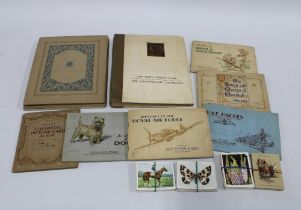 A collection of early 20th century cigarette card albums.