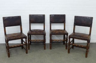 Set of four oak side chairs, with worn leather backs and stuffover seats, with barley twist