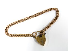 9ct gold curb link bracelet with a 9ct gold heart shaped padlock