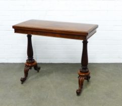 William IV rosewood card table by W & C Wilkinson, the fold over top standing on lappet carved