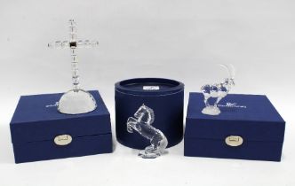 Three Swarovski boxed crystals to include a cross, stallion and an ibex, (3)