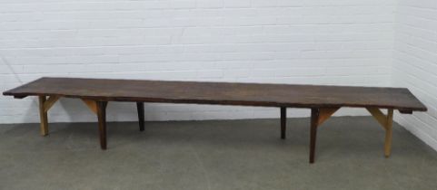 Handcrafted pine bench, long proportions with a loose upholstered cushion, 296 x 52 x 55cm.