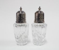 A pair of George V silver topped glass sugar casters, Birmingham 1934, 17cm (2)