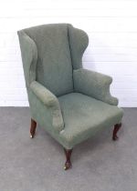 Early 20th century wing armchair, of small proportions, on cabriole legs with brass casters, with