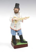 Russian bisque figure of a balalaika player, bears Gardner Porcelain Factory backstamp, 10 x 23cm.