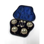 A cased set of four Victorian silver salts with four white metal condiment spoons, Sheffield 1867