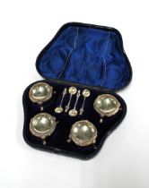 A cased set of four Victorian silver salts with four white metal condiment spoons, Sheffield 1867