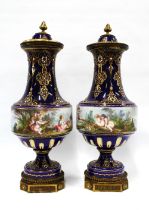 A pair of French lidded vases, with jewelled decoration and cobalt blue ground, with a handpainted