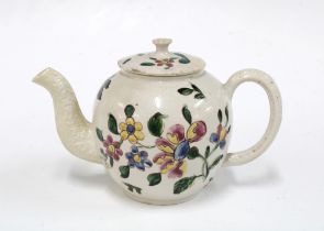 18th century miniature saltglazed teapot and cover, decorated with flowers in coloured enamels