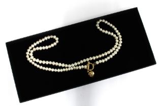 Contemporary pearl strand necklace with gold clasp, stamped 14k