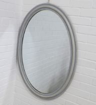 A contemporary grey painted and beaded frame wall mirror with an oval plate, 72 x 102cm.