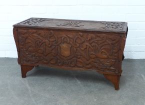 Manner of Alexander Ritchie, an early 20th century oak carved coffer, with celtic dragon pattern,
