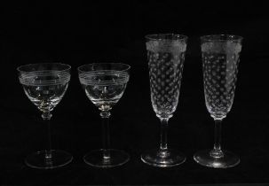 A pair of star etched glass champagne flutes and a pair of Art Deco style martini glasses (4) 18cm