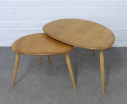 Ercol, a nest of two light elm and beech pebble tables, larger 66 x 40 x 44cm (2)