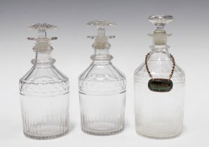 A pair of small ring necked decanters with stoppers and another of slightly larger size and of