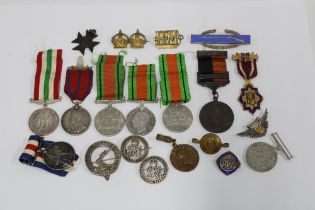 Quantity of WWI & WWII medals, military cap and lapel badges, some silver hallmarked and commemorat