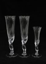 A pair of French champagne flutes with figural stems together with a smaller glass, 25cm (3)