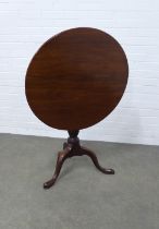 A mahogany tripod table, circular tilt-top, raised on triple splay supports with pad feet. 77 x