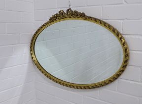 Gilt framed oval wall mirror, 73 x 49cm.