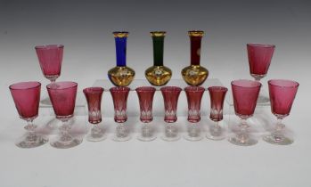 Set of six cranberry glass wine glasses with knop stems and a set of six smaller glasses and three