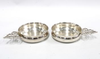 A pair of George VI silver wine tasters, each with a circular bowl and pierced handle, Sheffield
