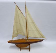 Model pond yacht with two cloth sails, on stand, 73 x 90cm