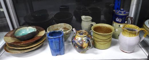 A collection of studio pottery to include a raku glazed bowl, teapot, jug and various bowls, (11)
