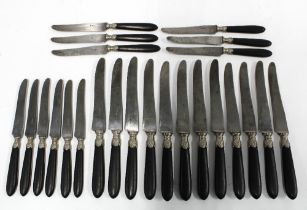 French Empire knives, c1850 with ebonised handles and white metal mounts and steel blades, inscribed