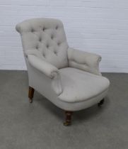 Button back upholstered armchair, scrolled top and arms, long proportioned seat, on turned legs with