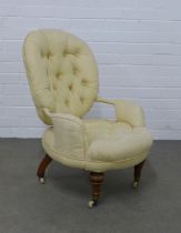 A button back upholstered armchair of small proportions, on mahogany legs with ceramic castors, 55 x