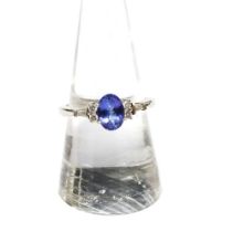 14ct white gold diamond and tanzanite dress ring, with an oval claw set tanzanite flanked by two