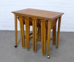 Vintage teak and stools folding nest, with a rectangular table and four circular topped stools