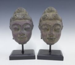 Pair of contemporary Thai style buddha heads on stands, 34cm (2)