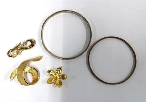 A gold plated bangle and another, costume jewellery brooches