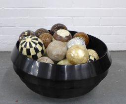 A large modern bowl/ tub containing a quantity of spheres in wood, rope and shell, etc (a lot)