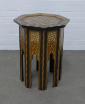 An eastern mother of pearl and inlaid octagonal table, 49 x 63cm.