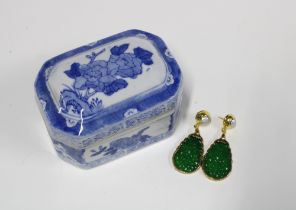 A pair of faux jade earrings and a small blue and white trinket box