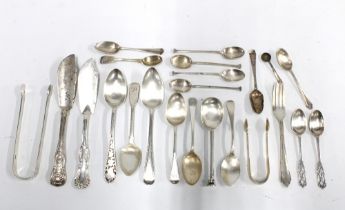 A quantity of silver flatware to include teaspoons, sugar tongs, butter knives, etc with mixed